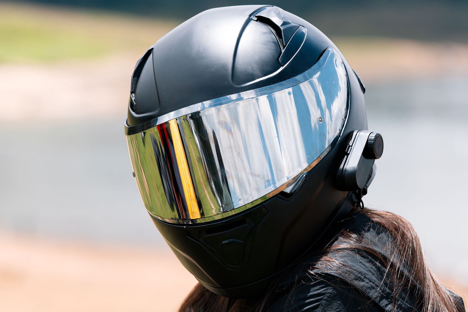 Motorcyclist wearing a modern helmet with Bluetooth intercom